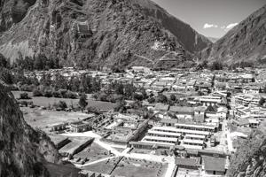 Archaeological ruins and village; granary on mountain in backgro